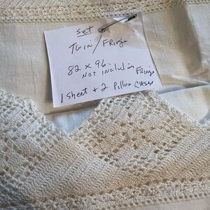 One vintage twin bed sheet w/two matching pillow cases. Never been used.